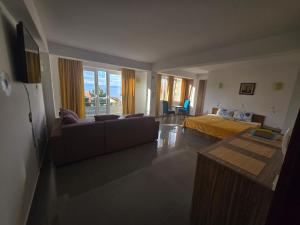 a living room with a bed and a couch at Yard House Trpejca in Ohrid