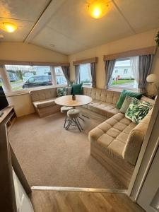 a living room with a couch and a table at Haighs caravan hire in Rhyl