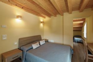 a bedroom with a bed and a wooden ceiling at Agriturismo Saettà in Lentiai