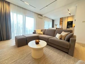 a living room with a couch and a table at Apartmani Eterović in Baška Voda