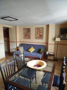 a living room with a couch and a table and chairs at Los Chinchanes in Santa Cruz de Grío