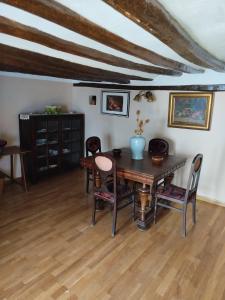 a dining room with a wooden table and chairs at Los Chinchanes in Santa Cruz de Grío