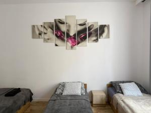 a room with two beds and a wall with a picture at Apartamenty na Witosa in Nowa Sól +20 photos