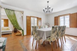 a dining room with a table and chairs at Sol Lua House in Fátima +36 photos