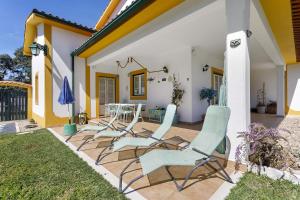 a group of chairs sitting on a patio at Sol Lua House in Fátima