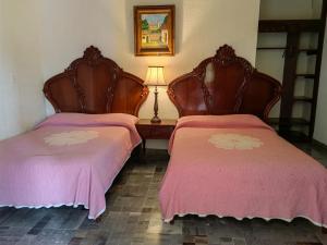 two beds sitting next to each other in a room at Hotel Tlacotalpan in Tlacotalpan