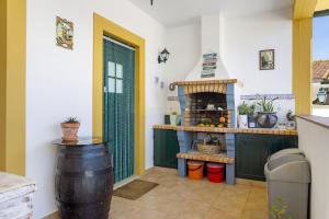 a kitchen with a barrel and a fireplace at Sol Lua House in Fátima