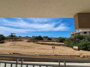 a view of a field from a building at Lanyard Hitch Court in Marsaxlokk
