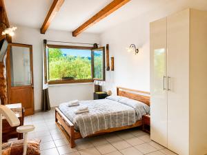 a bedroom with a bed and a window at La Fontanella in Montecchia di Crosara
