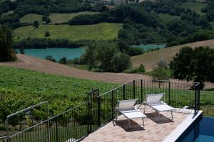 two chairs on a patio with a view of two reservoirs at La Corte Sul Lago in Cingoli