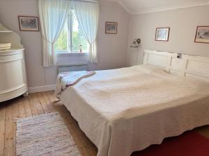 a bedroom with a large bed and a window at Hus Hultsnäs in Högsby