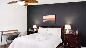 a bedroom with a large white bed with two night stands at Copperopolis Home - Lake Access & Mtn Views in Copperopolis