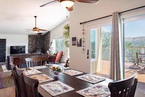 a dining room and living room with a table and a balcony at Copperopolis Home - Lake Access & Mtn Views in Copperopolis