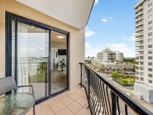a balcony with a table and chairs and a view of a city at Nautilus Private Rooftop Spa in Mooloolaba +6 photos