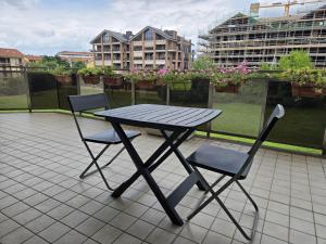 a picnic table and two chairs on a balcony at La casa nel parco in Chieri
