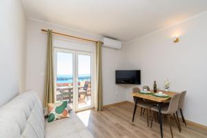 a living room with a couch and a table at Apartments Andrija in Palit