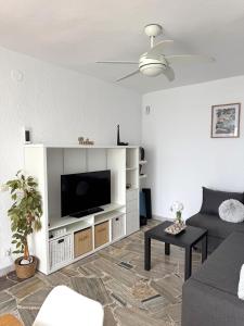 a living room with a flat screen tv on a entertainment center at Villa Blue Paradise in Vinarós