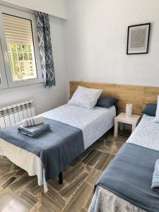 a bedroom with two beds and a window at Villa Blue Paradise in Vinarós