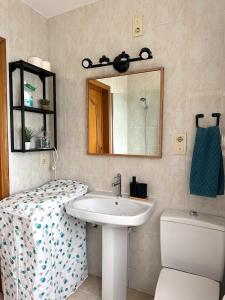 a bathroom with a sink and a mirror and a toilet at Villa Blue Paradise in Vinarós +41 photos