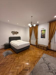 a bedroom with a bed and a wooden floor at Insieme Studio - Small Square in Sibiu +4 photos