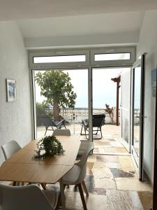 a dining room with a table and a view of the ocean at Villa Blue Paradise in Vinarós