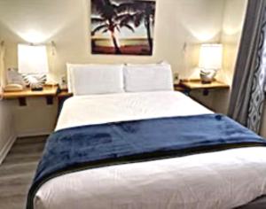 a bedroom with a large bed with two night stands at Royal Holiday Beach Resort in Biloxi +69 photos