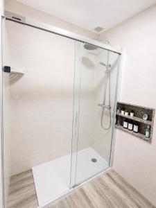 a shower with a glass door in a bathroom at APARTAMENTOS LA CAPILLA in Villanueva de Arosa +43 photos