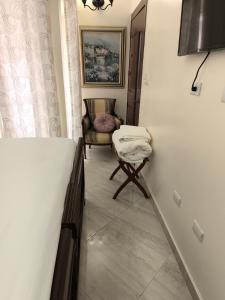 a room with a bed and a chair in it at Caribbean Luxury Penthouse in San Felipe de Puerto Plata