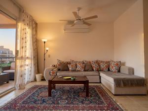 a living room with a couch and a table at 396 Blumar Chalet North Coast Sidi-abdelrahman families & couples only in El Alamein