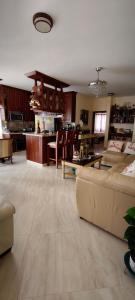 a living room with a couch and a kitchen at Caribbean Luxury Penthouse in San Felipe de Puerto Plata