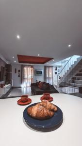 a loaf of bread on a table in a living room at NURAS - Casa degli Anemoni in Porto Conte