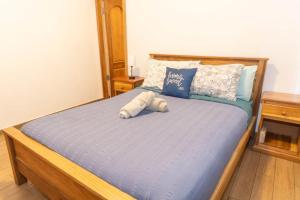 a bed with a stuffed animal on top of it at Chango's Apartments in Bocas Town