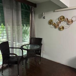 a dining room with a glass table and chairs at Diamond Palace in Kingston