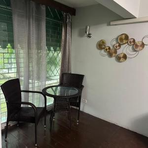 a dining room with a glass table and chairs at Diamond Palace in Kingston
