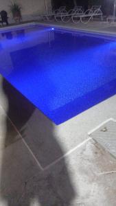 a blue swimming pool in a room at Coin du paradis in Saly Portudal