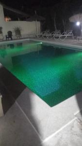 a swimming pool with green water in a house at Coin du paradis in Saly Portudal