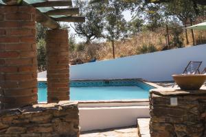 a swimming pool in a villa with a house at Horta dos Cismeiros, Monsaraz - Monte Alentejano com Piscina in Monsaraz