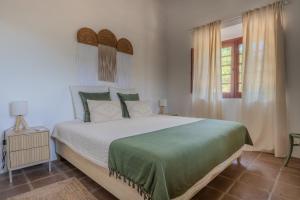a bedroom with a large bed and a window at Horta dos Cismeiros, Monsaraz - Monte Alentejano com Piscina in Monsaraz +18 photos