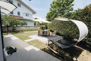 a patio with a table and an umbrella at Athena Garden House in Montesilvano