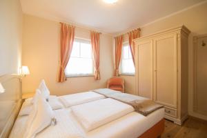 A bed or beds in a room at Gutshof Sinn