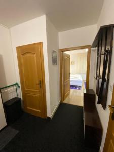a hallway with a door and a room with a bed at Apartmán Hollého 2 in Trenčín +2 photos