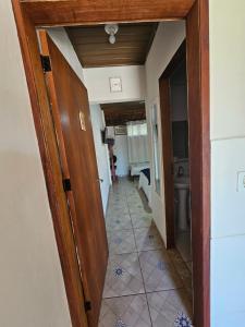 a hallway with a door open to a bathroom at Flat Sol Paraty in Paraty