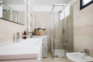 a white bathroom with a sink and a shower at Athena Garden House in Montesilvano +31 photos