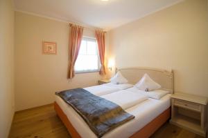 A bed or beds in a room at Gutshof Sinn