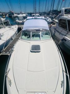 a white boat is docked in a harbor at VINA ROMANCE - Romantic Boat Stay in Lisbon Marina in Lisbon