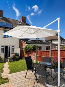 a patio with a table and a white umbrella at 3-Bedroom House ,Quiet & Spacious in Kent