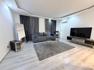a living room with a couch and a flat screen tv at Eliasar2 in Linz