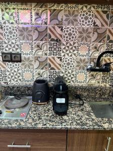 a kitchen counter top with a toaster and a toaster at Studio ALADIN in Rabat