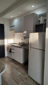a kitchen with white appliances and a white refrigerator at Monoambiente 4 de enero in Santa Fe