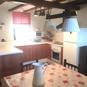 a kitchen with a table with a vase on it at Casita del Castillo Mora de Rubielos in Mora de Rubielos